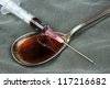 stock-photo--drug-syringe-and-cooked-heroin-on-spoon-117216682.jpg