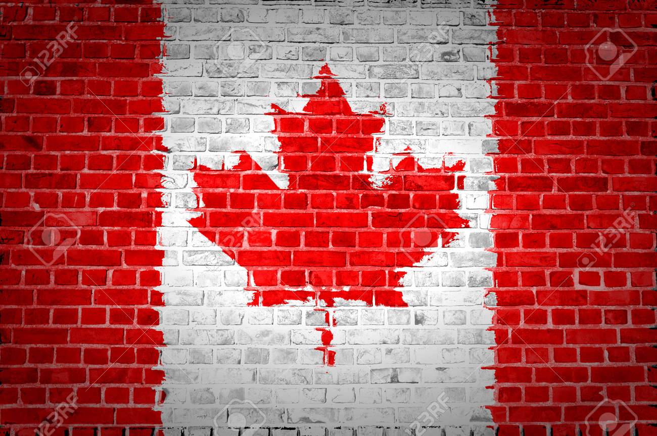 12423036-An-image-of-the-Canada-flag-painted-on-a-brick-wall-in-an-urban-location-Stock-Photo.jpg