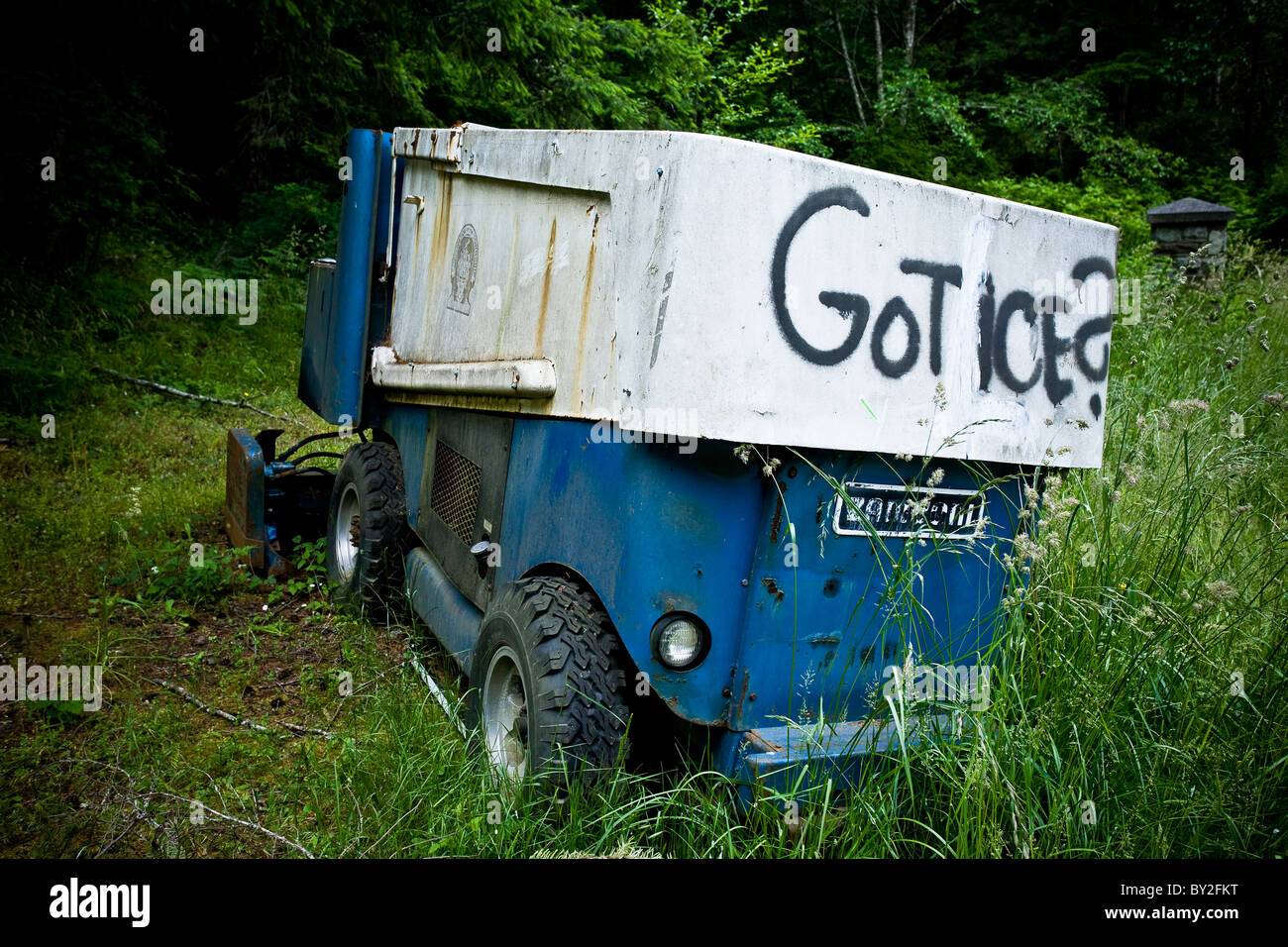 broken-down-zamboni-ice-machine-in-the-woods-with-got-ice-spray-painted-BY2FKT.jpg