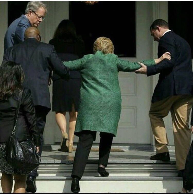 Hillary-Clinton-Helped-Up-Steps.jpg