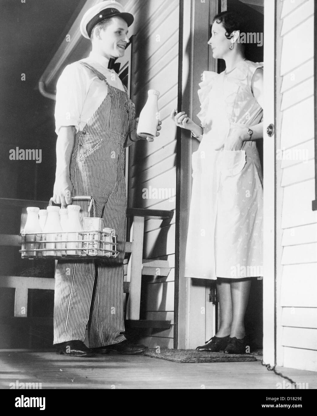 historic-shot-of-milk-man-delivering-milk-to-housewife-D1829E.jpg