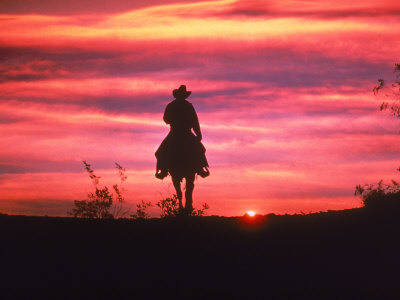 ewing-galloway-silhouette-of-cowboy-on-horse-at-sunset.jpg