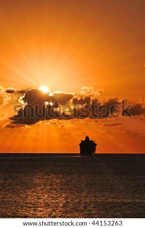 stock-photo-cruise-ship-sailing-into-the-sunset-with-sunburst-effect-44153263.jpg