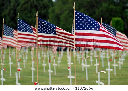 stock-photo-american-flags-with-white-crosses-at-cemetery-11372866.jpg