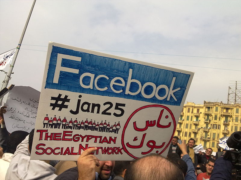 egyptian-protester-carrying-facebook-jan25-sign.jpg