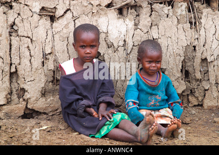 maasai-children-masai-village-showing-mud-hut-made-of-sticks-and-cow-anwnc4.jpg