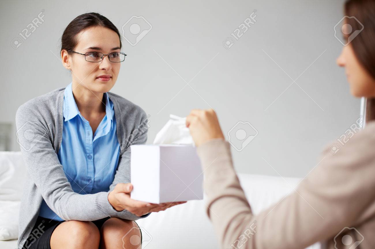 23254653-Careful-psychiatrist-giving-box-with-paper-tissues-to-her-patient-Stock-Photo.jpg