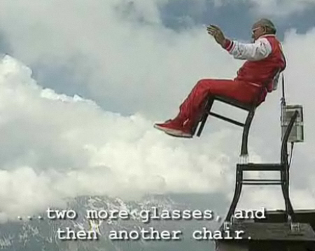 man-balances-chair-over-mountain-cliff.jpg