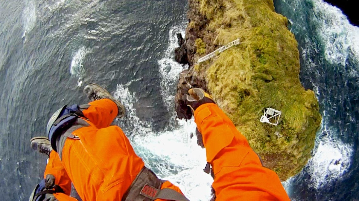 another-key-job-of-the-coast-guard-is-to-maintain-navigation-service-aids-throughout-the-waters-around-alaska-here-an-electronics-technician-is-lowered-to-a-fixed-aid-on-an-island-in-cold-bay.jpg