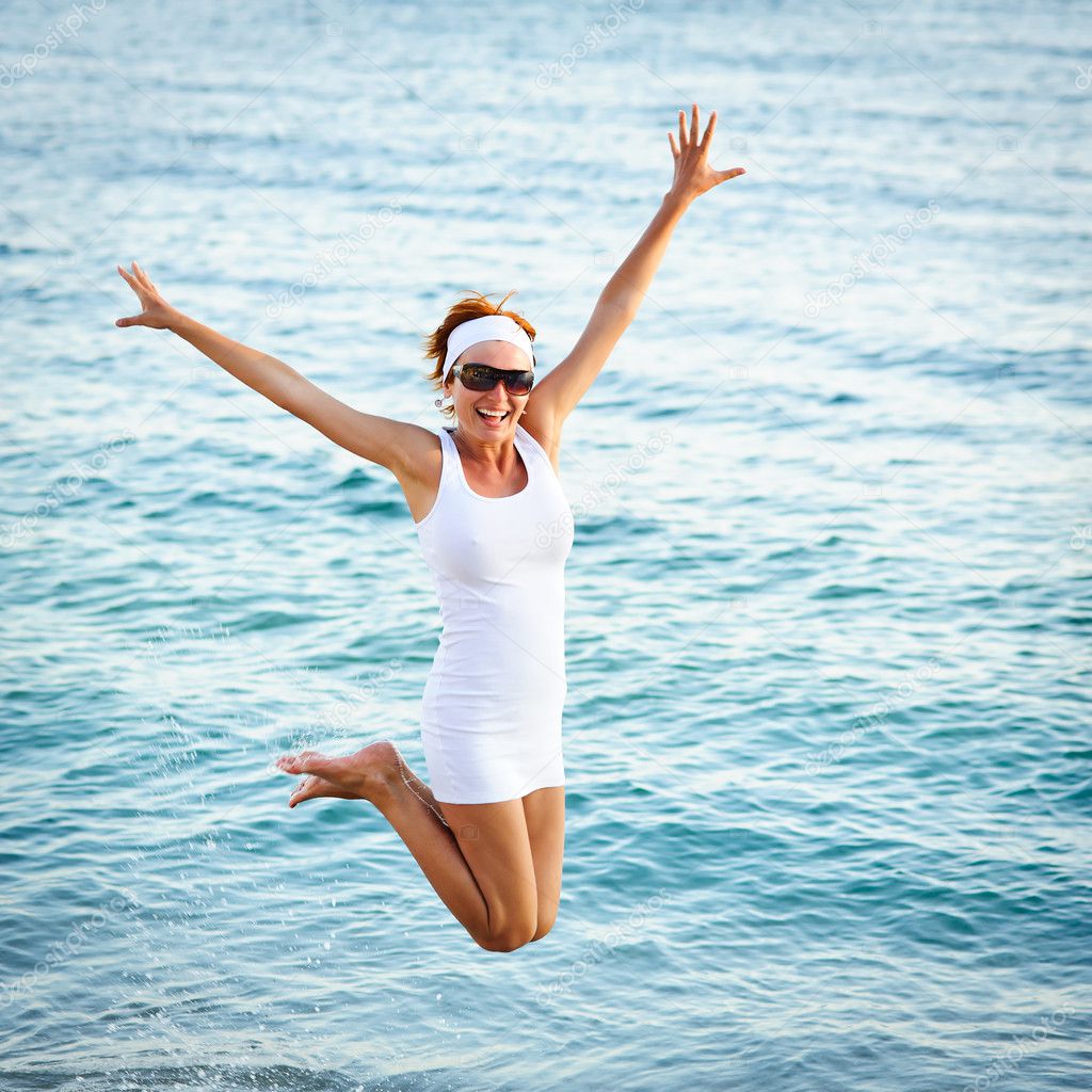 depositphotos_6345386-Happy-young-woman-is-jumping-in-the-beach.jpg