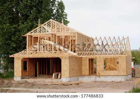 stock-photo-a-new-stick-built-home-under-construction-177486833.jpg
