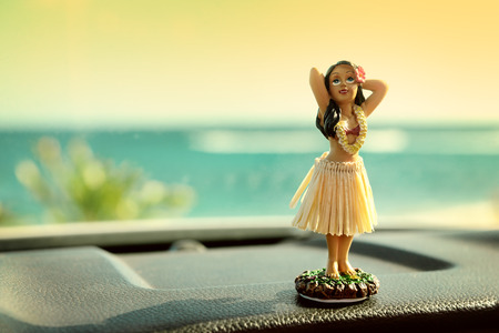 40414898-hula-dancer-doll-on-hawaii-car-road-trip-doll-dancing-on-the-dashboard-in-front-of-the-ocean-tourism.jpg