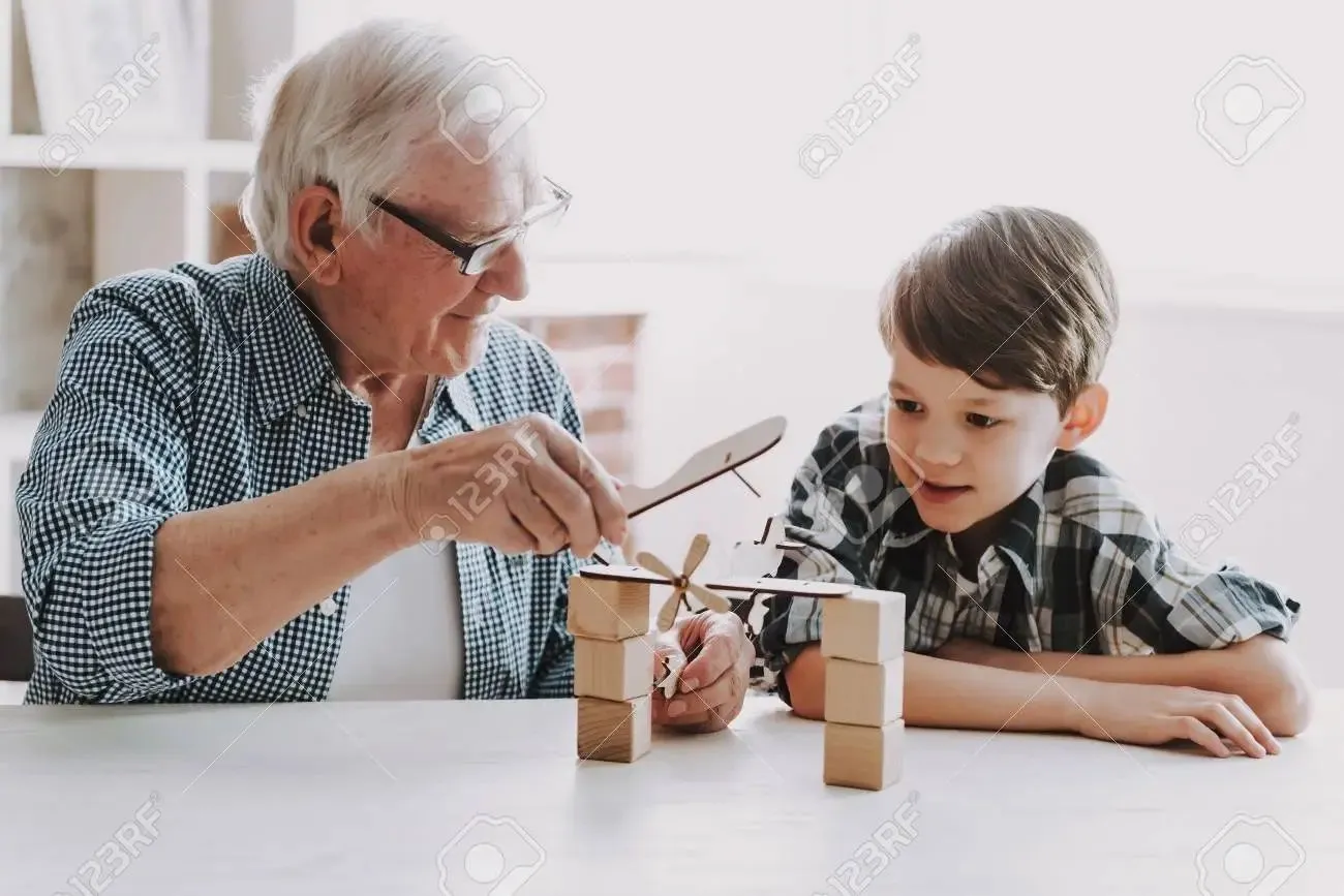 107349589-grandpa-and-grandson-playing-with-toys-at-home-family-relationship-between-grandfat...webp