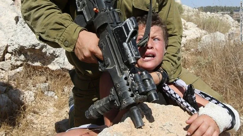 150830073831-01-israeli-soldier-arrests-palestinian-boy-exlarge-169[1].webp