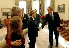 President George W. Bush congratulates Senator Mike DeWine, R-Ohio, on S.  650, the Pediatric Equity