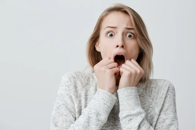 astonished-terrified-attractive-young-blonde-with-dyed-hair-female-sweater-having-scared-face...webp