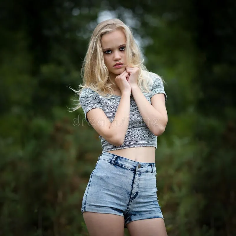 bautiful-blond-teenage-girl-alone-woods-location-portrait-beautiful-young-wearing-denim-short...webp