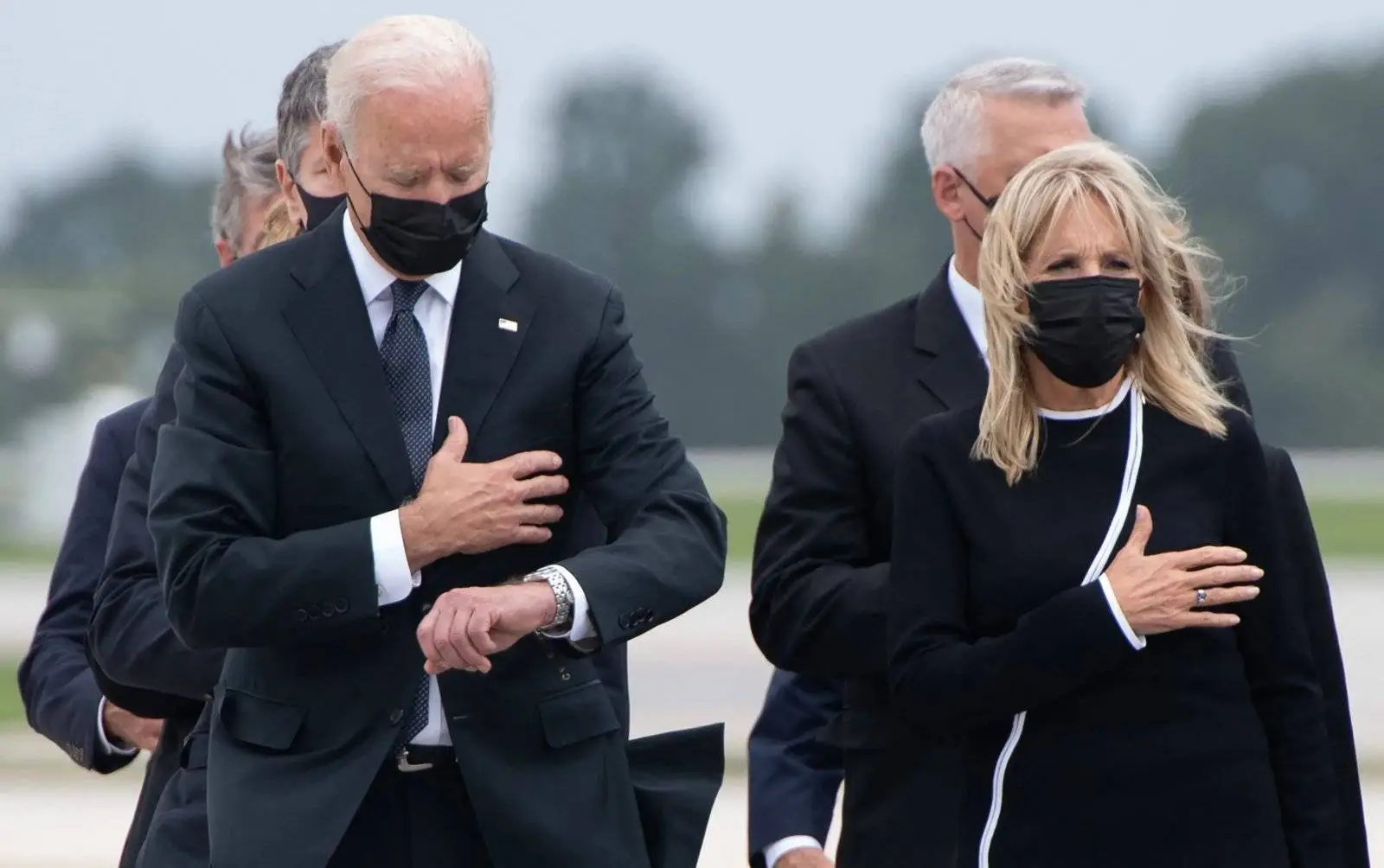 biden checking his watch.webp