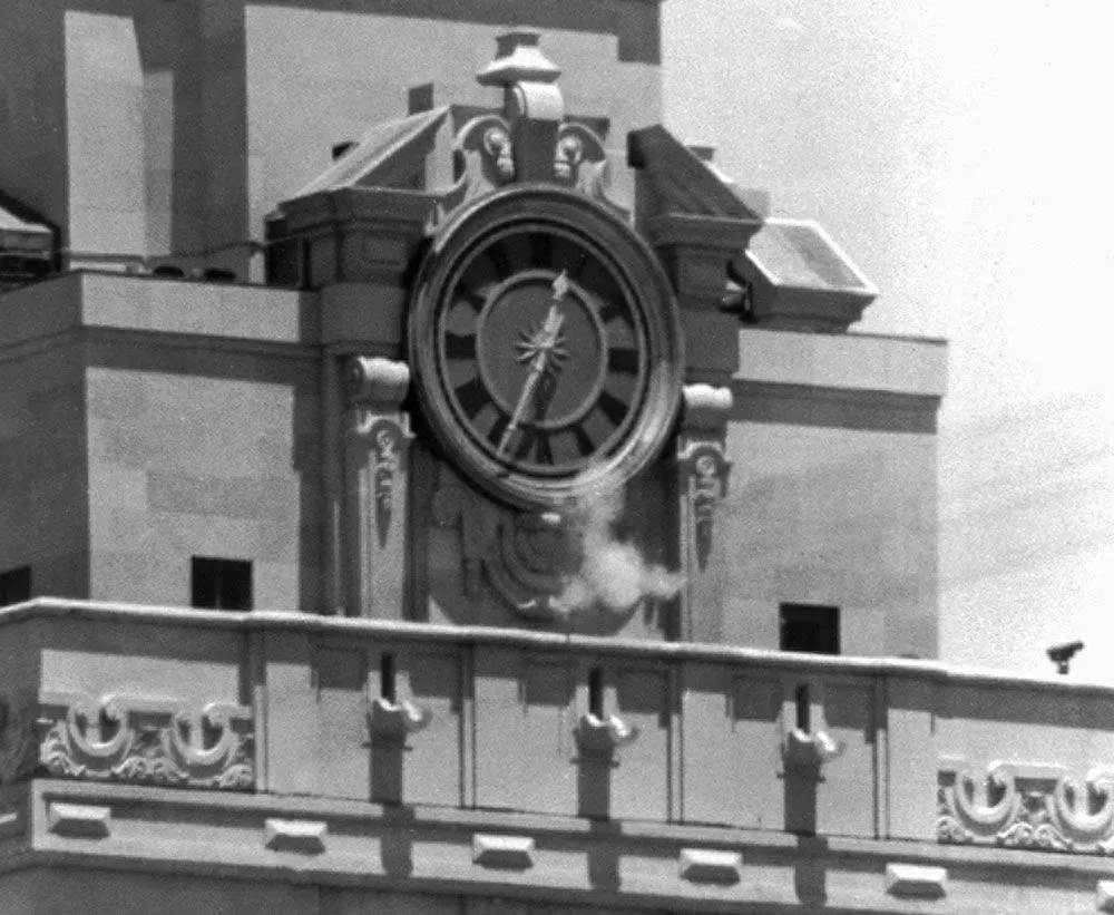 Charles-Joseph-Whitman-Smoke-gun-clock-tower-August-1-1966.webp
