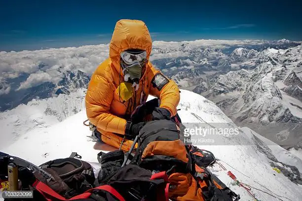 climber-on-summit-of-mount-everest-picture-id103323099.webp