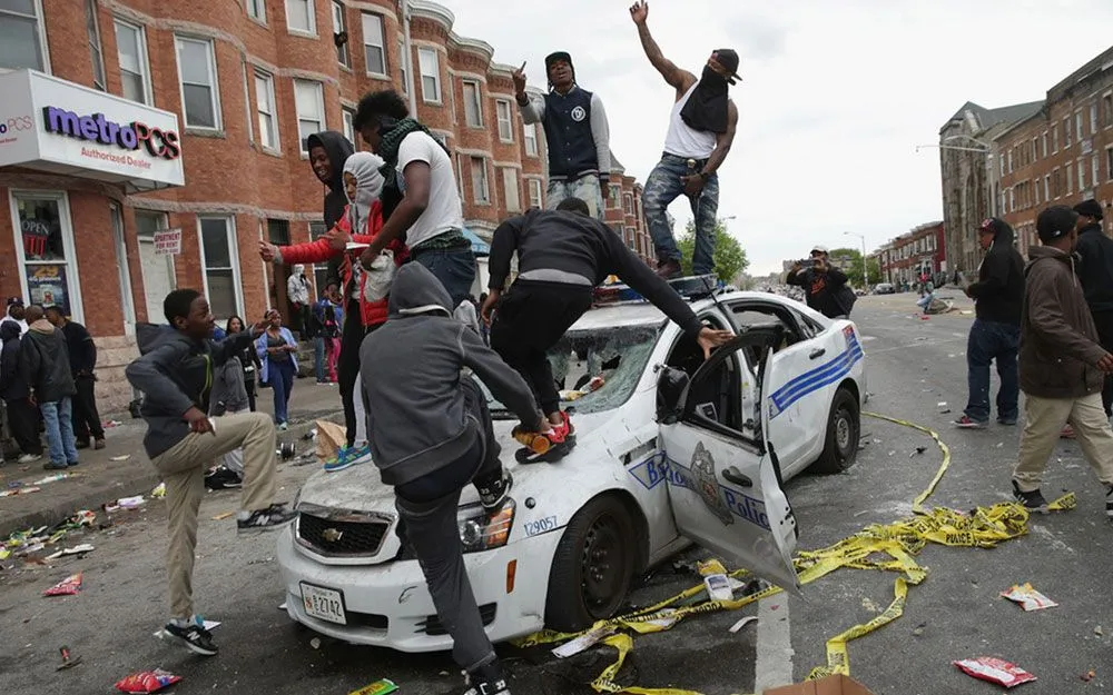 Ferguson-Black-Thug-Criminals-FDance-On-Destroyed-Police-Car.webp