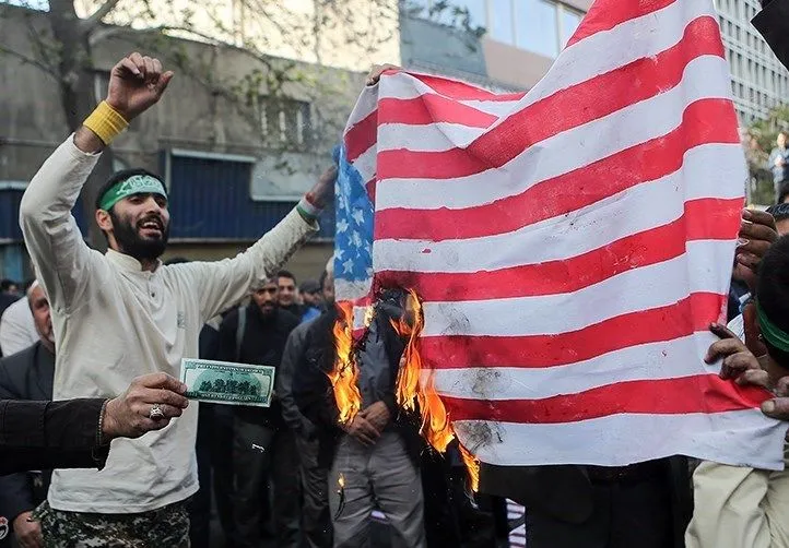 Iranian_Protesters_Burning_USA_Flag.webp