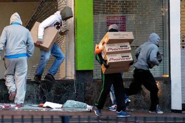 looters-carry-boxes-out-of-a-home-cinema-shop-in-central-birmingham-pic-reuters-30054029.webp