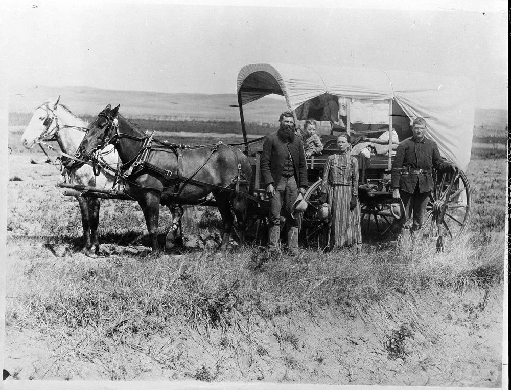Photograph+of+a+Family+with+Their+Covered+Wagon+During+the+Great+Western+Migration_NARA.webp