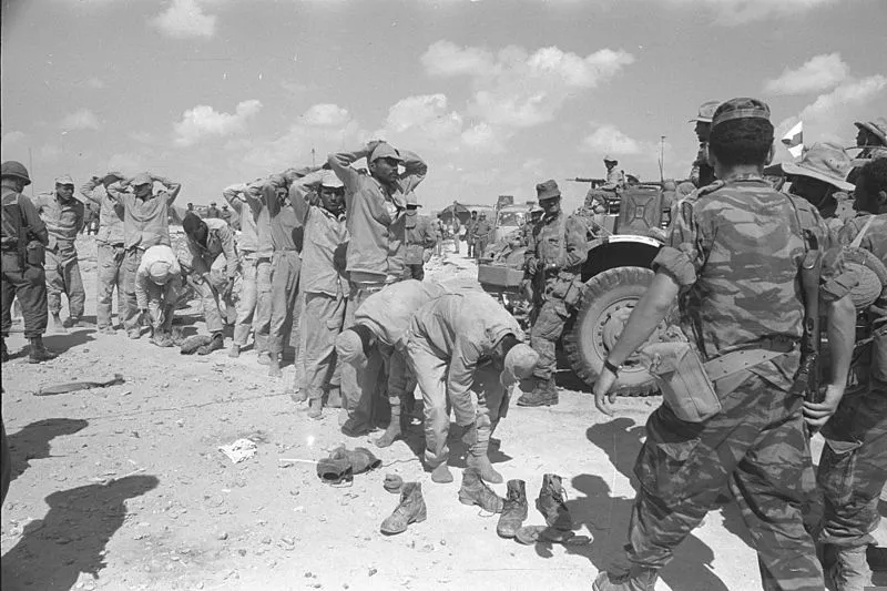 Six_Day_War._Egyptian_prisoners_of_war_being_rounded_up_outside_El_Arish._June_1967._D326-061.webp