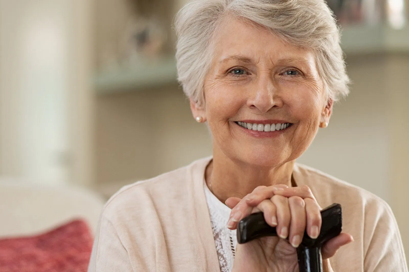 Smilng-attractive-older-woman-with-cane-iStock-1029340842.webp