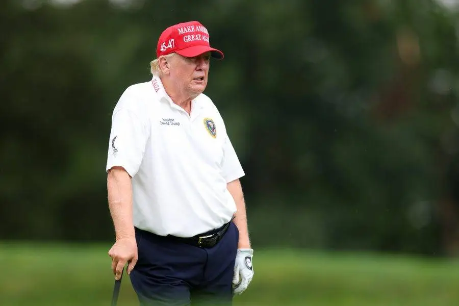 trump king of debt lousy body slumped golf course.webp