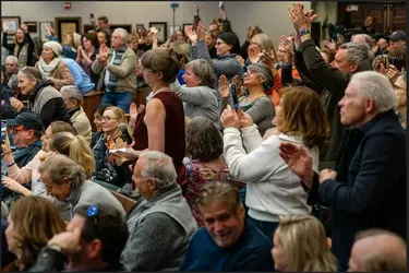Applause and cheers follow a question at the McCormick town hall about President Donald Trump...webp