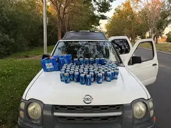 BEER CANS ON HOOD.webp BEER CANS ON HOOD.webp