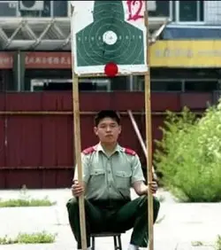 $man holds target sign.webp