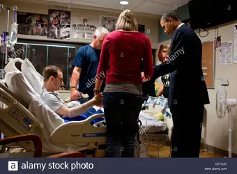 us-president-barack-obama-prays-with-a-wounded-service-member-and-D1TCA7.webp