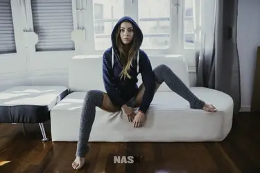 women_spread_legs_couch_hoods_strategic_covering_blonde_Nask_Nach_Marisol_Gonzalez-315970.webp