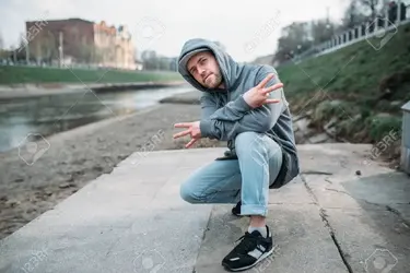 78999865-male-rapper-posing-on-the-street-urban-dancing.webp
