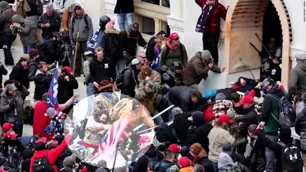 210110210555-capitol-riot-officer-beating-american-flag-super-tease.webp