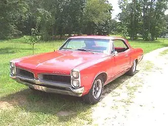 $1966_Pontiac_Le_Mans_2-Door_Hardtop_Red_Frt_Qtr.webp