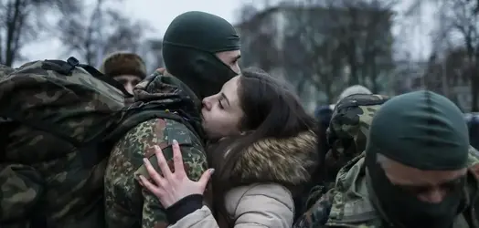 A-new-volunteer-for-the-Ukrainian-Interior-Ministry-s-Azov-battalion-embraces-hi.jpg