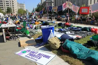 $OWS planet before profits sign.webp