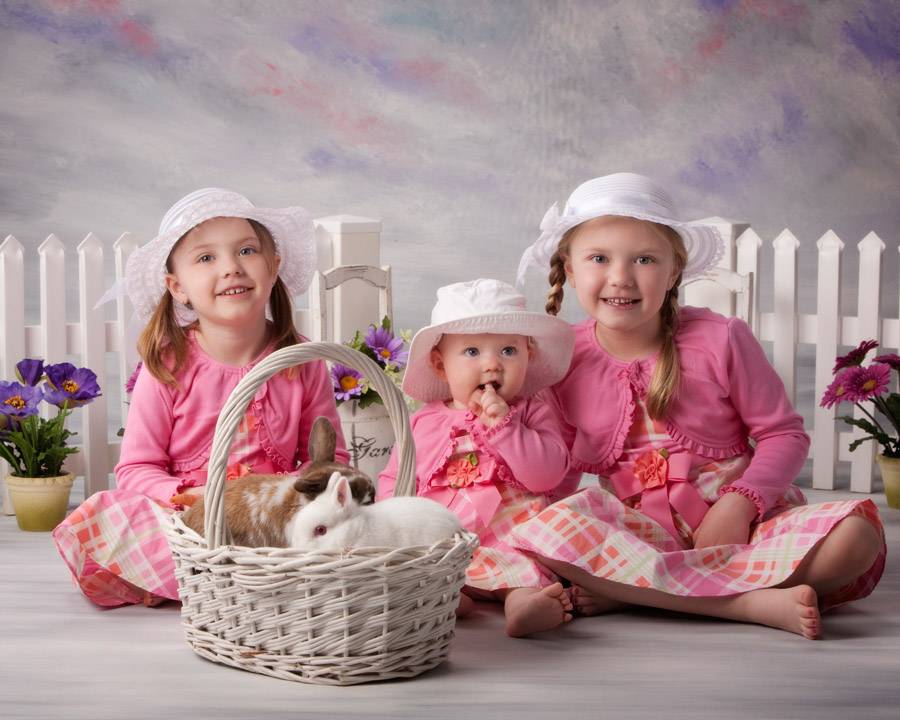 childrens-easter-portraits-three-sisters-dressed-in-matching-pink-outfits-with-two-bunnies.jpg
