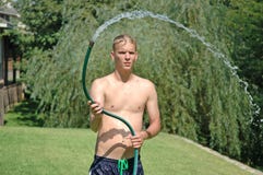 young-man-garden-hose-567277.jpg