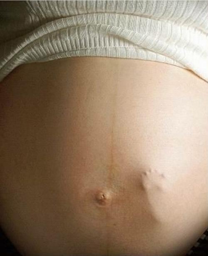baby-foot-on-mommys-belly-by-scratch.jpg