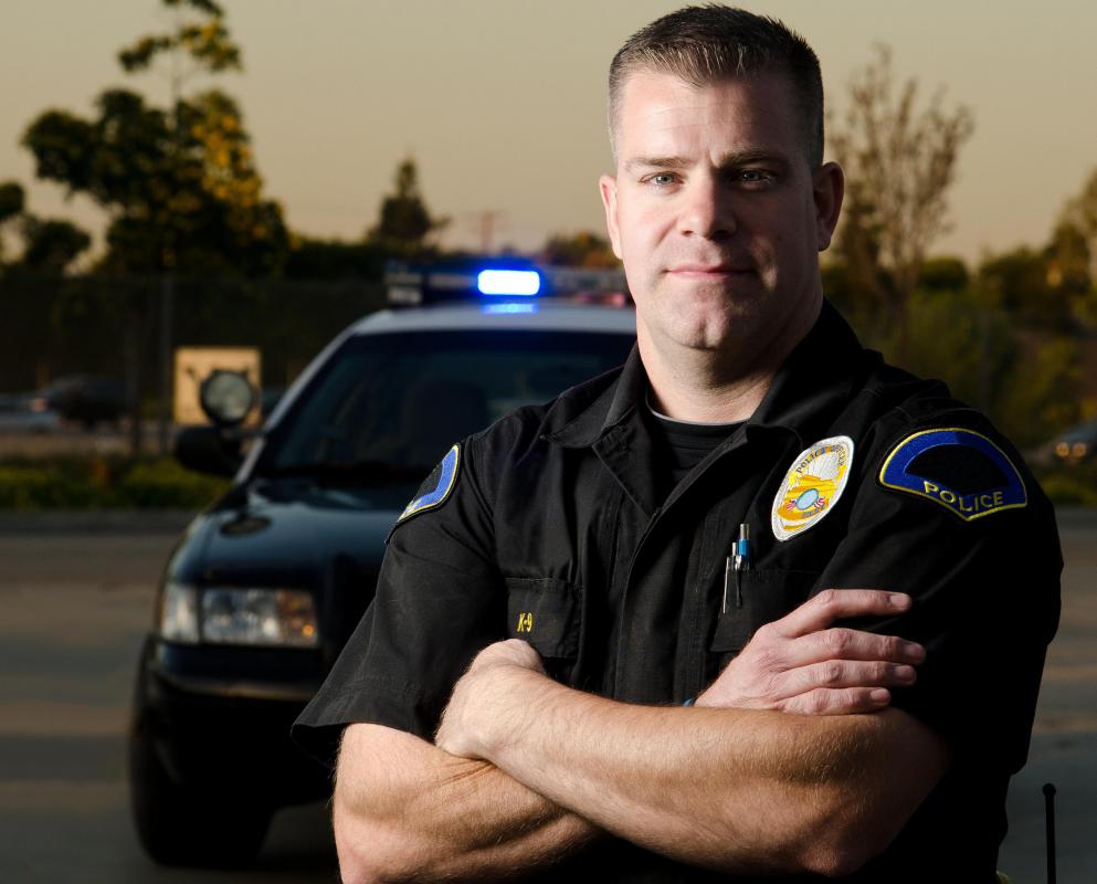 policeman-with-arms-crossed-near-car.jpg