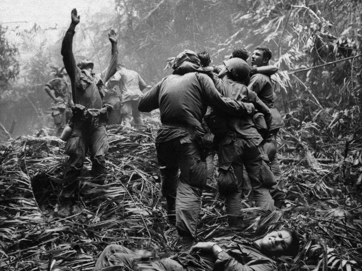 here-as-fellow-troopers-aid-wounded-comrades-the-first-sergeant-of-a-company-101st-airborne-division-guides-a-medevac-helicopter-through-the-jungle-foliage-to-pick-up-casualties-suffered-during-a-five-day-patrol-near-hue-in-vietnam-in-april-1968.jpg