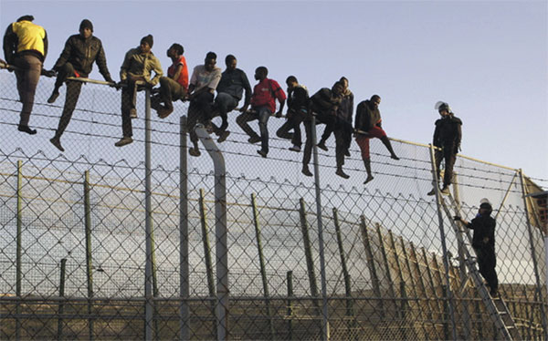immigrants_over_fence.jpg
