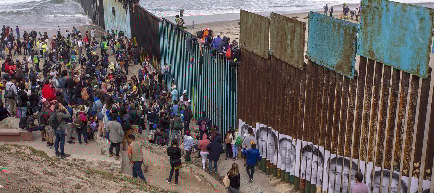 Border-wall-migrants-e1525386526123.jpg