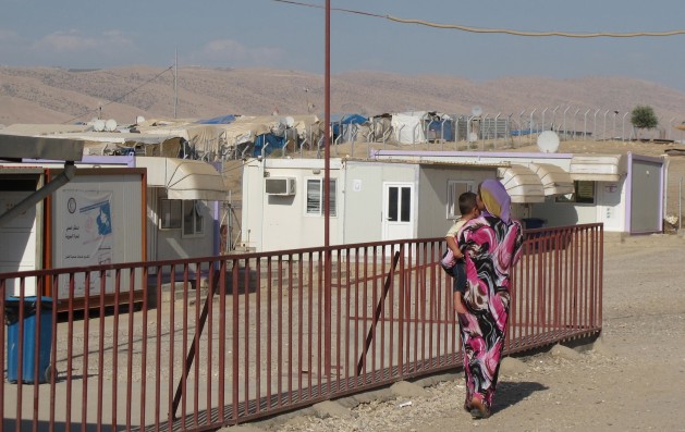 A-young-mother-walks-approaches-a-healthcare-facility-within-the-Domiz-refugee-camp-in-Iraqi-Kurdistan-in-mid-September-2014--629x397.jpg