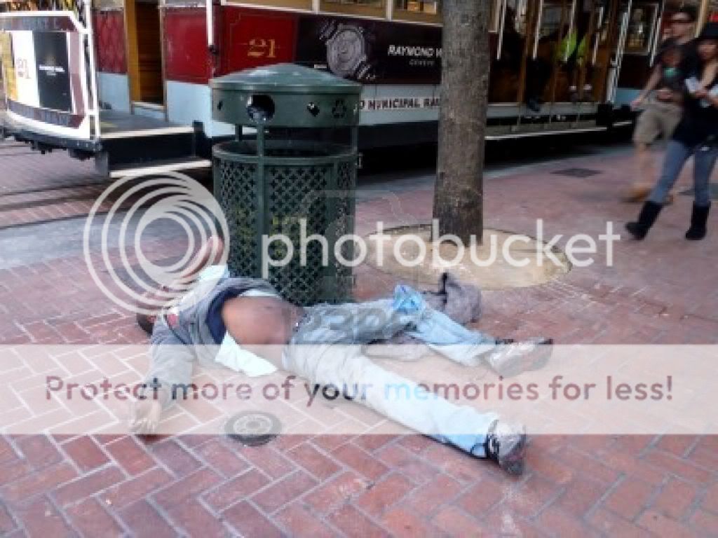 8707582-san-francisco--august-24-homeless-man-sleeps-on-ground-resting-against-a-trash-can-next-to-cable-car-1.jpg